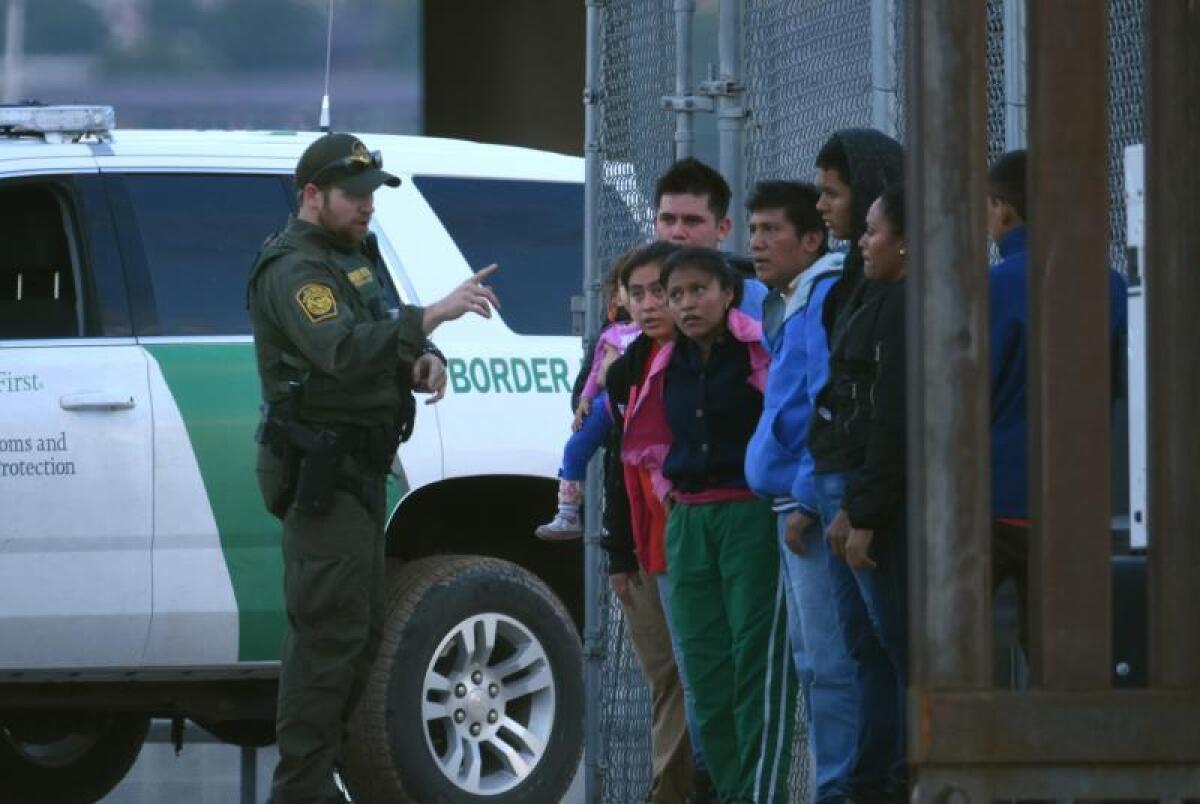 Un agente de la patrulla fronteriza estadounidense habla a un grupo de jóvenes migrantes centroamericanos tras ser detenidos en los margenes del Rio Bravo, en la fronteriza Ciudad Juárez (México). EFE/Rey R. Jauregui/Archivo