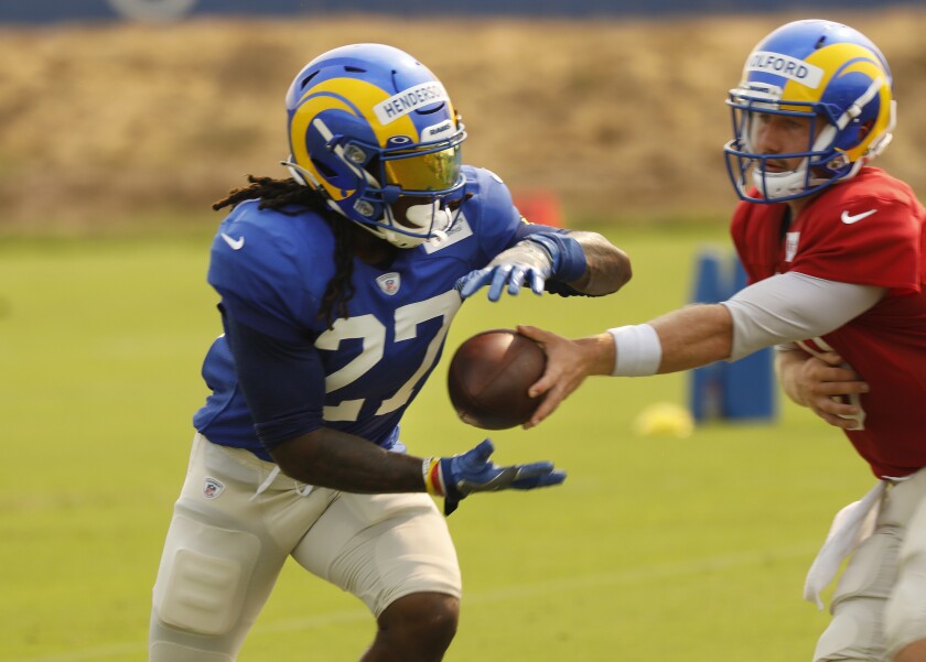 Rams running back Darrell Henderson takes a handoff during practice.