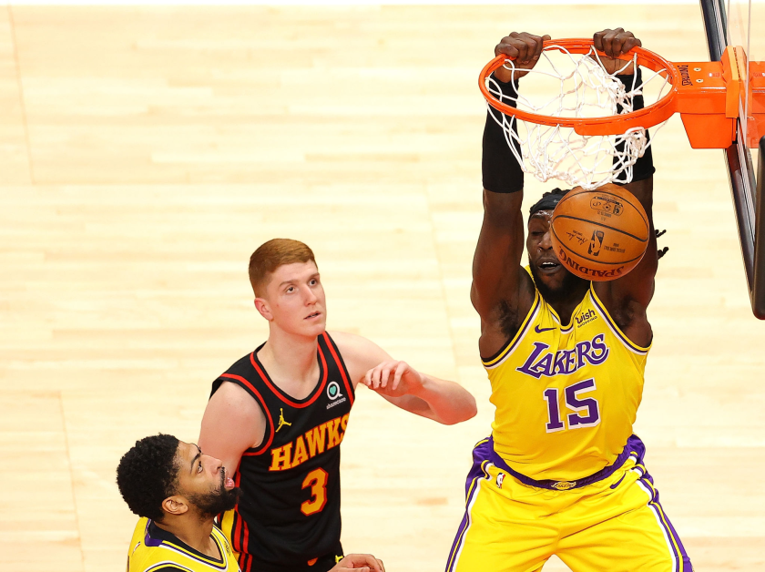 Montrezl Harrell dunks as the Atlanta Hawks' Kevin Huerter (3) and the Lakers' Anthony Davis look on Monday night.