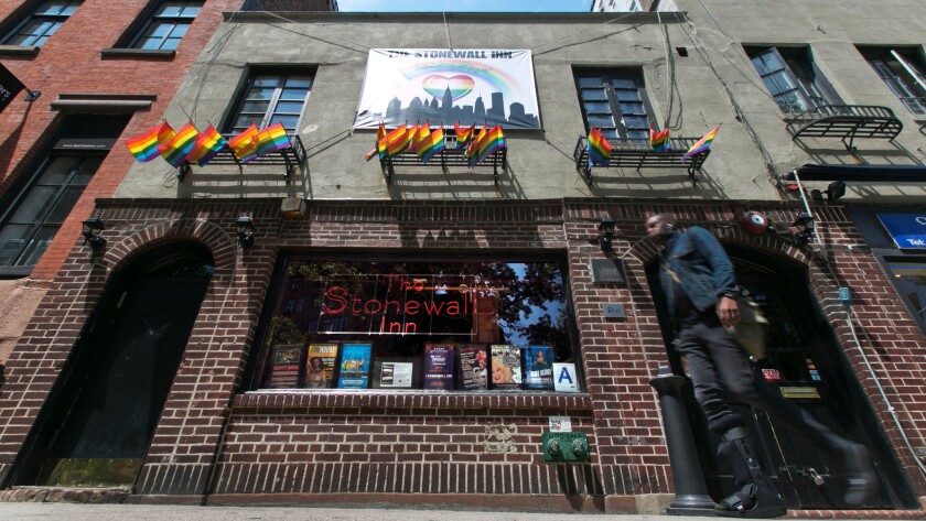 A man passes the Stonewall Inn in New York's Greenwich Village. President Obama has designated the Stonewall Inn a national monument, the first to honor gay rights.