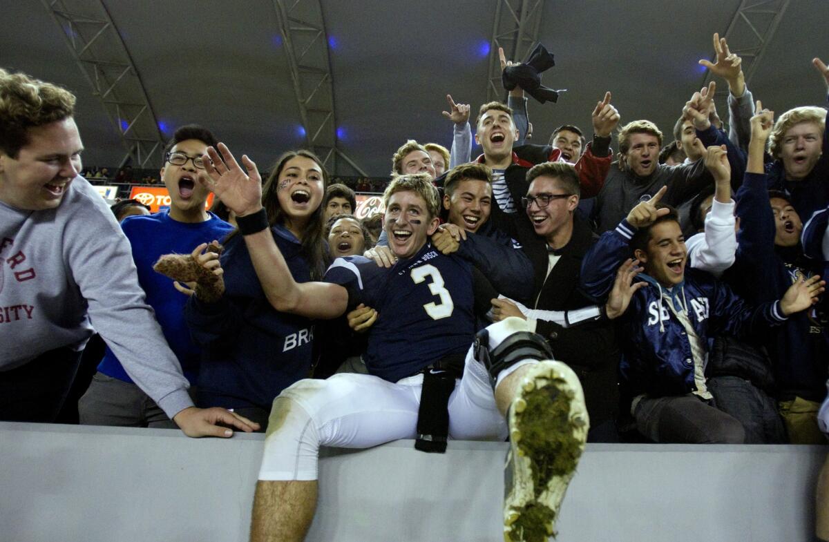 St. John Bosco quarterback Josh Rosen celebrates with students and fans following the Braves' 20-14 victory over Concord De La Salle in the CIF state championship Open Division bowl game.