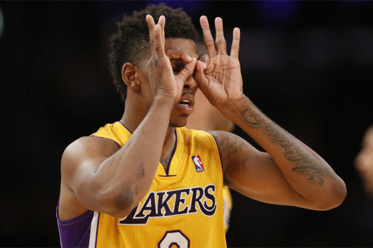Lakers forward Nick Young dons his "3-point goggles" as he celebrates a basket against the Portland Trail Blazers.