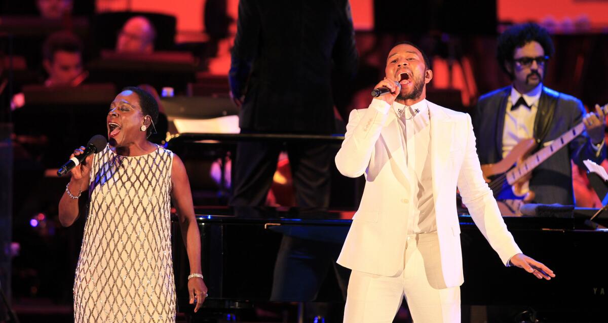 Sharon Jones and John Legend sing together at Legend's tribute concert to singer Marvin Gaye at the Hollywood Bowl on Wednesday night.