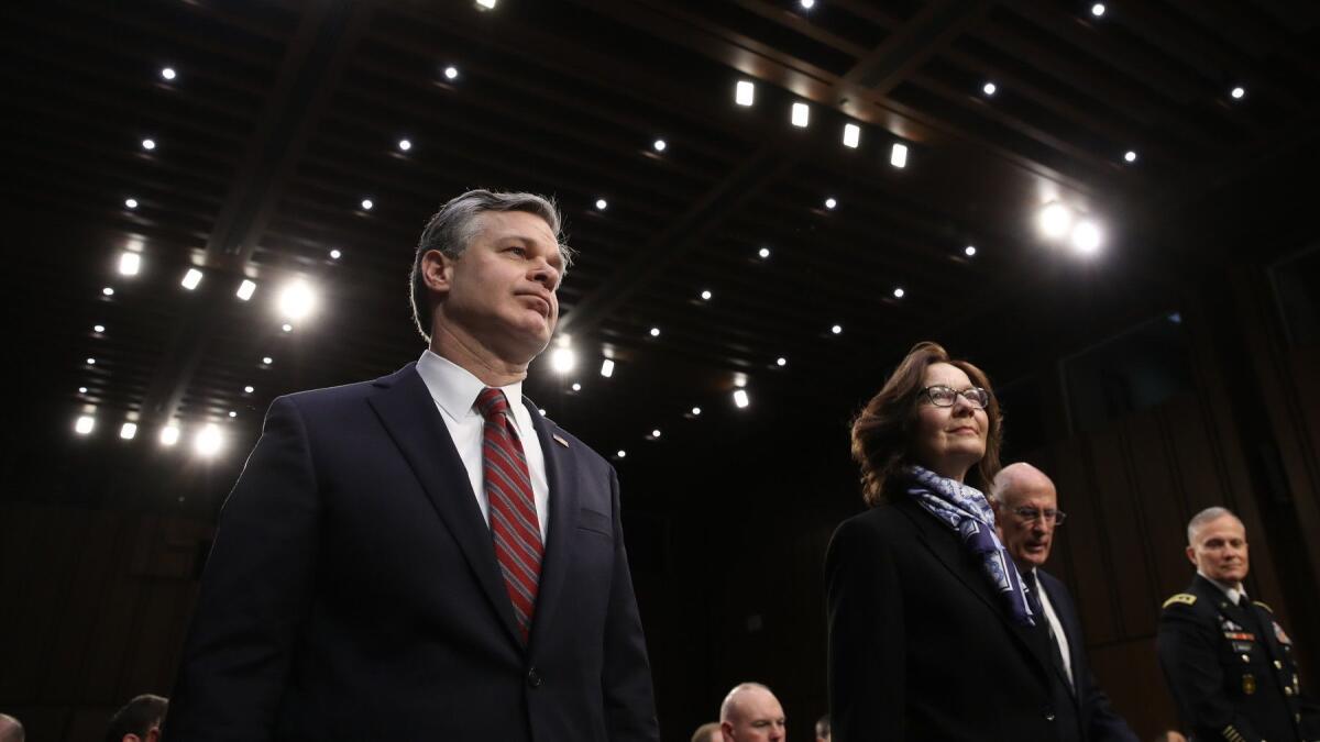 FBI Director Christopher Wray, left, CIA Director Gina Haspel and National Intelligence Director Dan Coats, second from right, appear before the Senate Intelligence Committee on Tuesday.