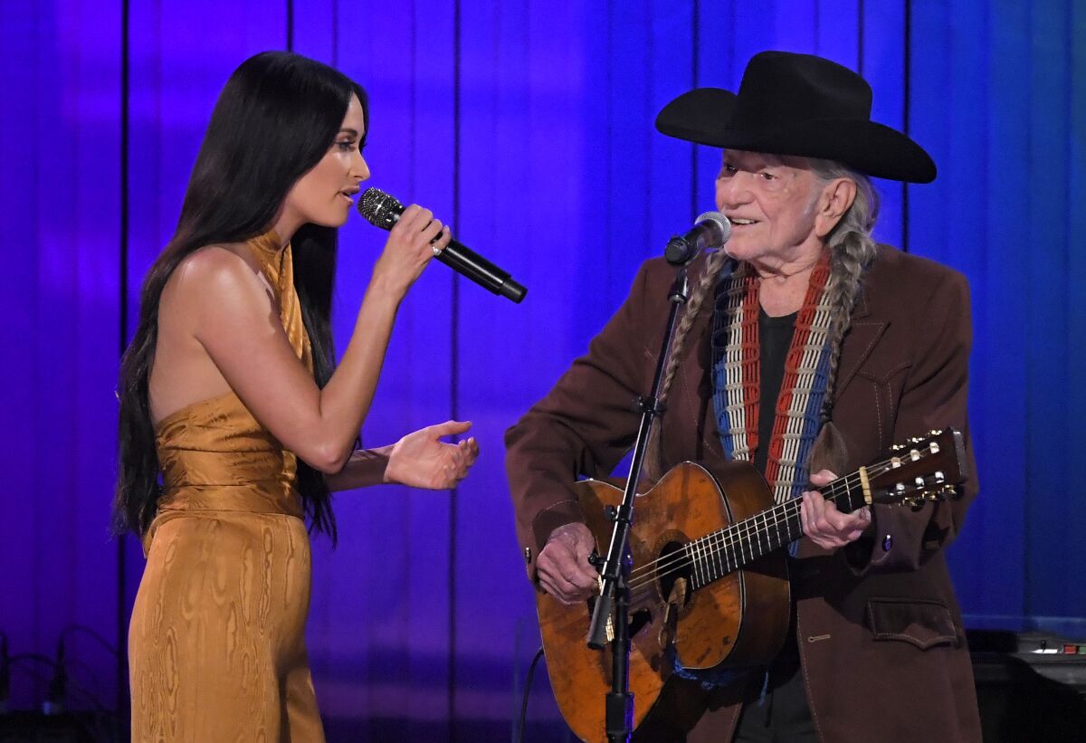 Kacey Musgraves, left, and Willie Nelson