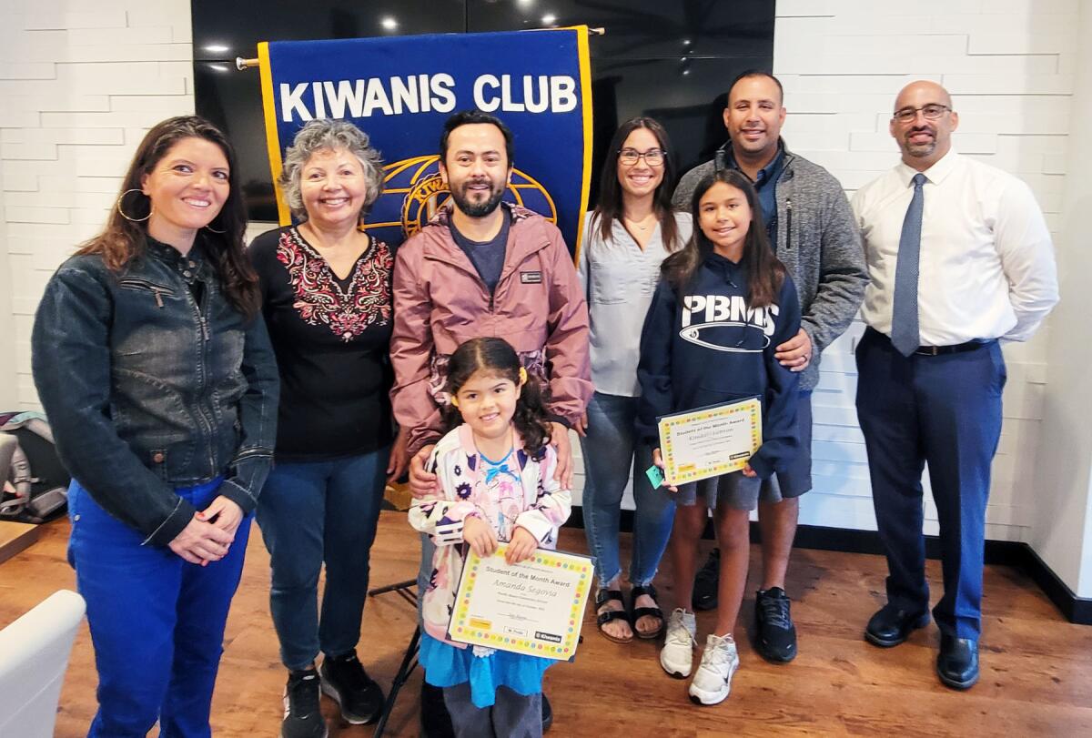 honored students with parents, teacher