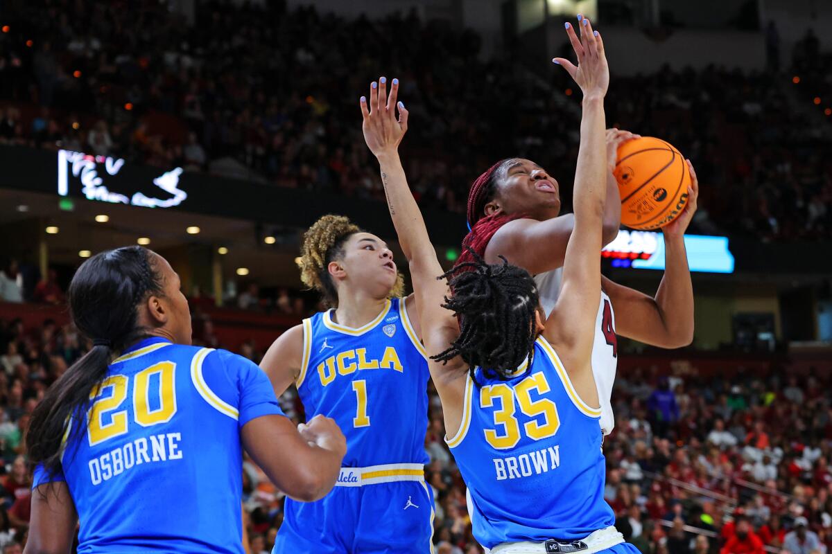 South Carolina's Aliyah Boston puts up a shot in front of UCLA's Charisma Osborne, Kiki Rice and Camryn Brown.