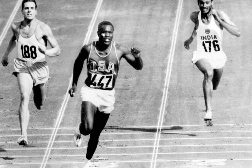 FILE - In this Sept. 5, 1960, file photo, Rafer Johnson of the United States, center, finishers the fourth heat of the decathlon 100 meter dash at the Olympics in Rome, Italy. Eef Kamerbeek of Netherlands is at left, and Gurbachan Singh Randhawa of India is at right. Rafer Johnson, who won the decathlon at the 1960 Rome Olympics and helped subdue Robert F. Kennedy's assassin in 1968, died Wednesday, Dec. 2, 2020. He was 86. He died at his home in the Sherman Oaks section of Los Angeles, according to family friend Michael Roth. (AP Photo/Olympic Pool, File)