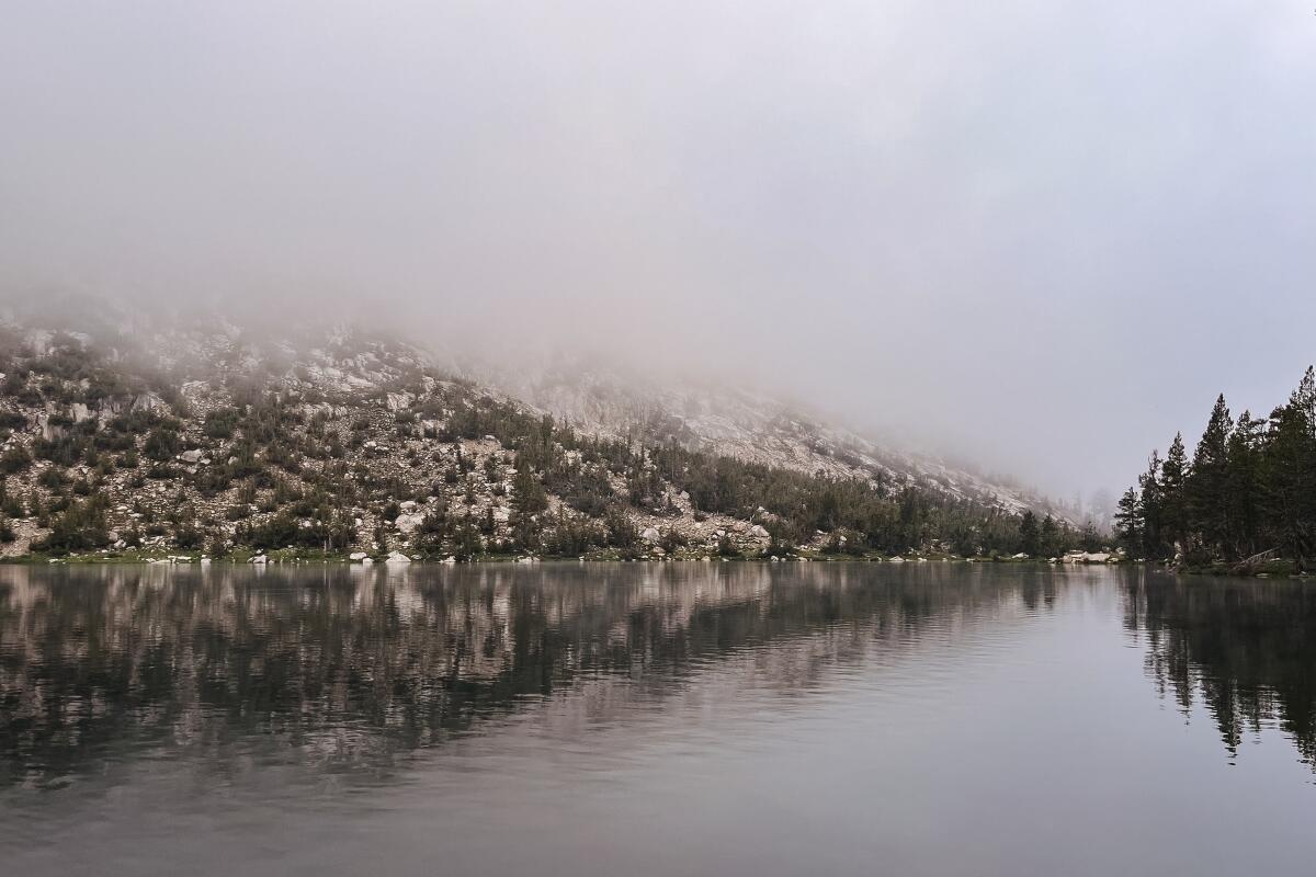 Fog hovers over a lake.