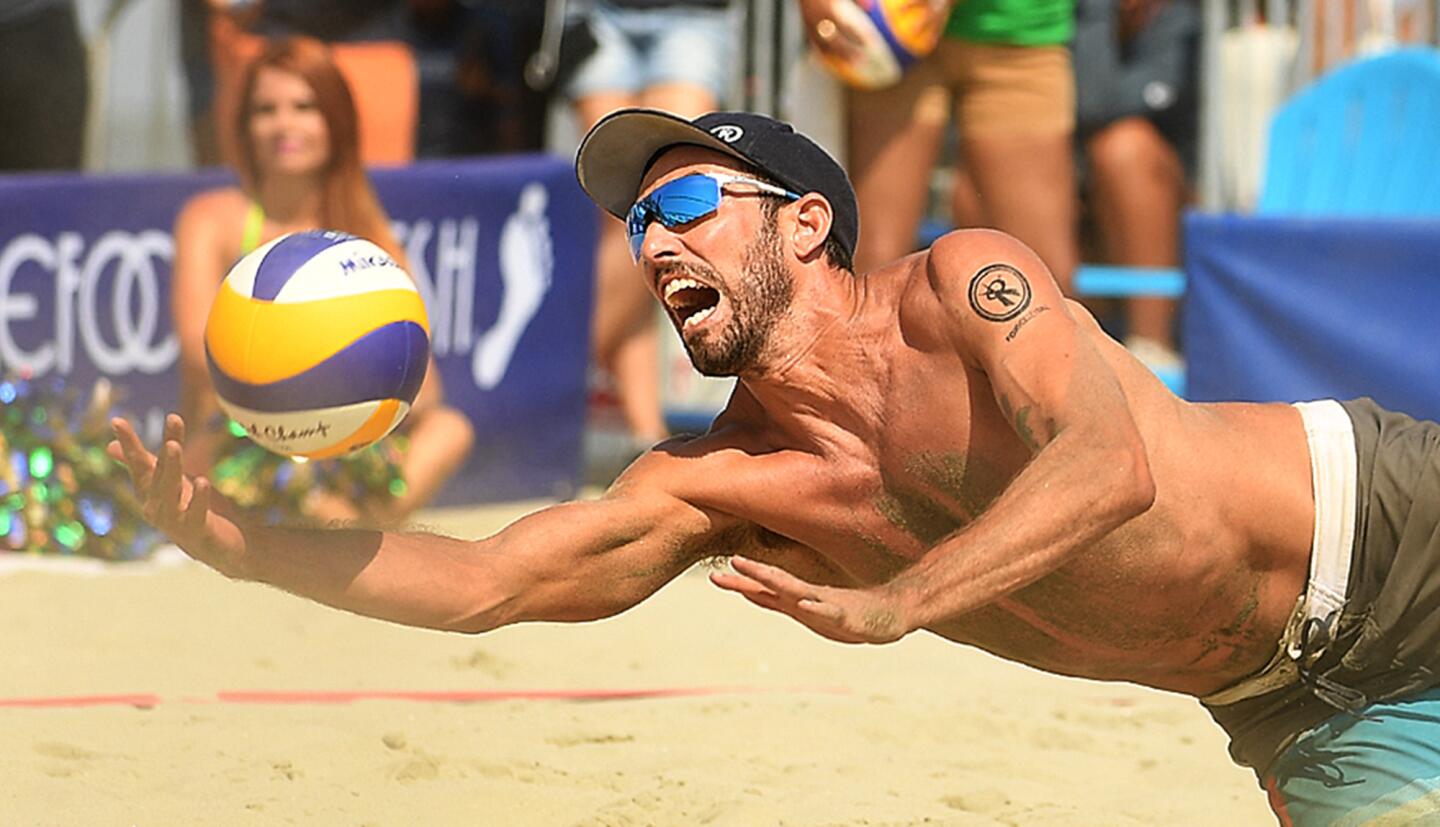 Nick Lucena dives for the ball during the Men's World Series of Beach Volleyball final in Long Beach.