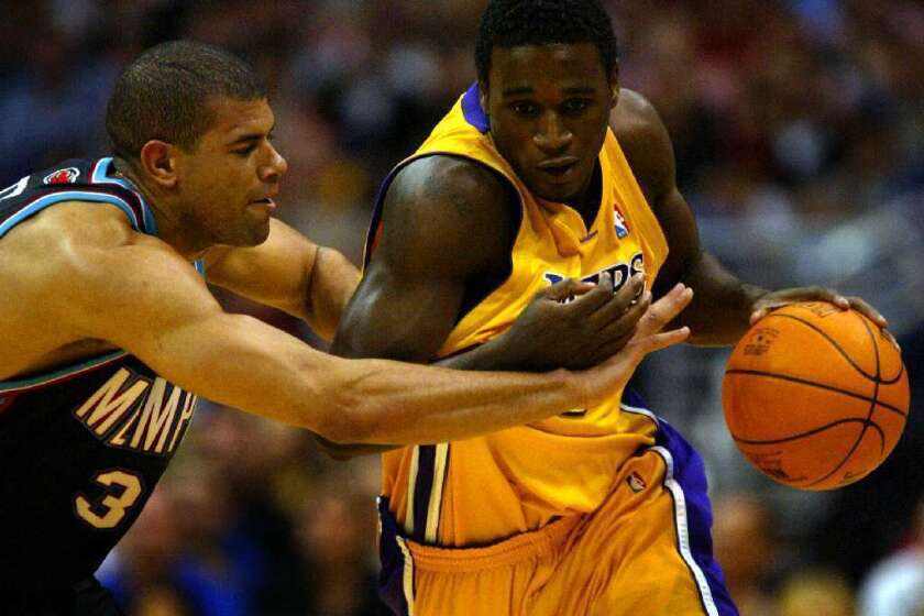 Kareem Rush, right, playing for the Lakers in 2004, fights off Shane Battier.