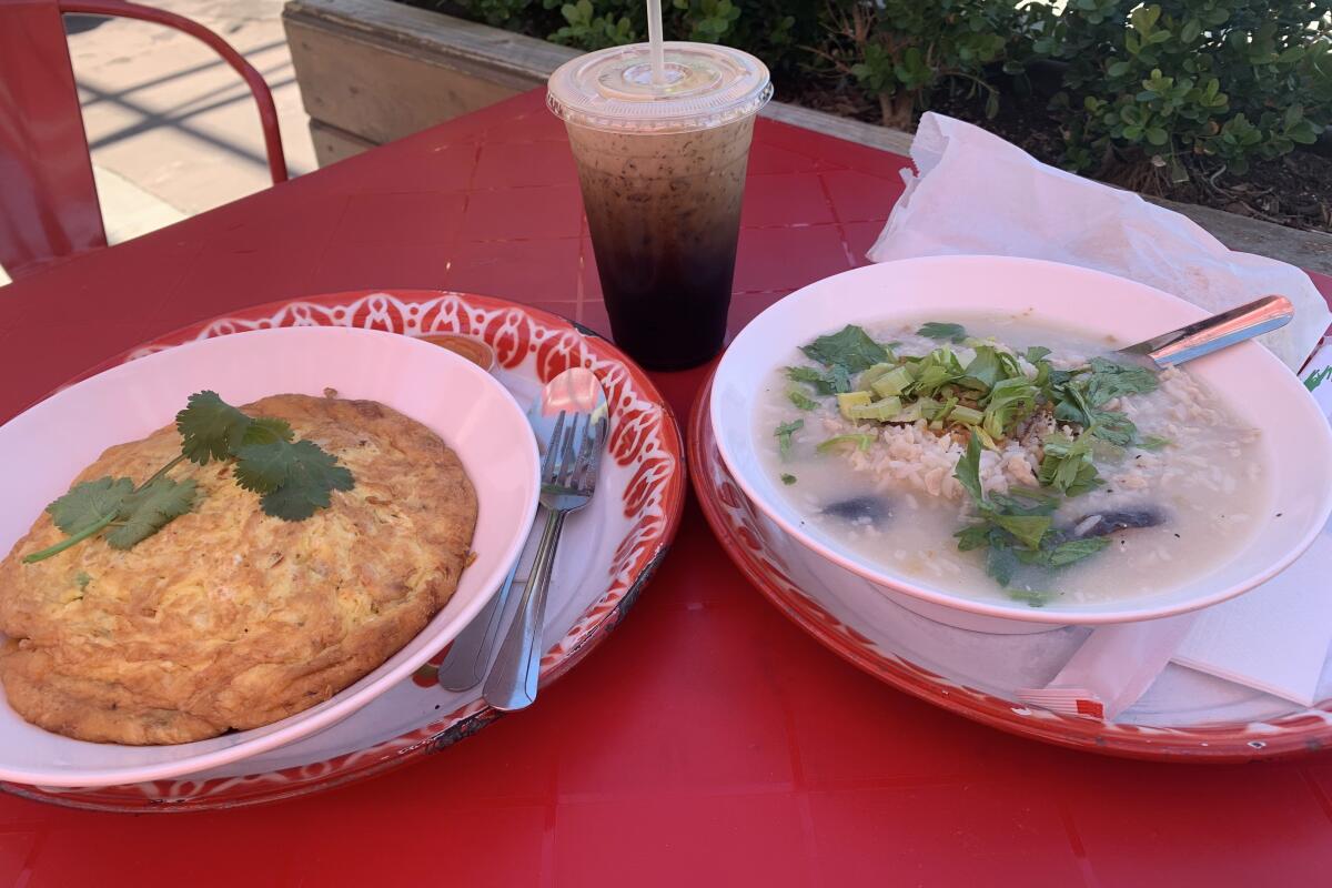 A crab omelet and rice porridge with an iced coffee 