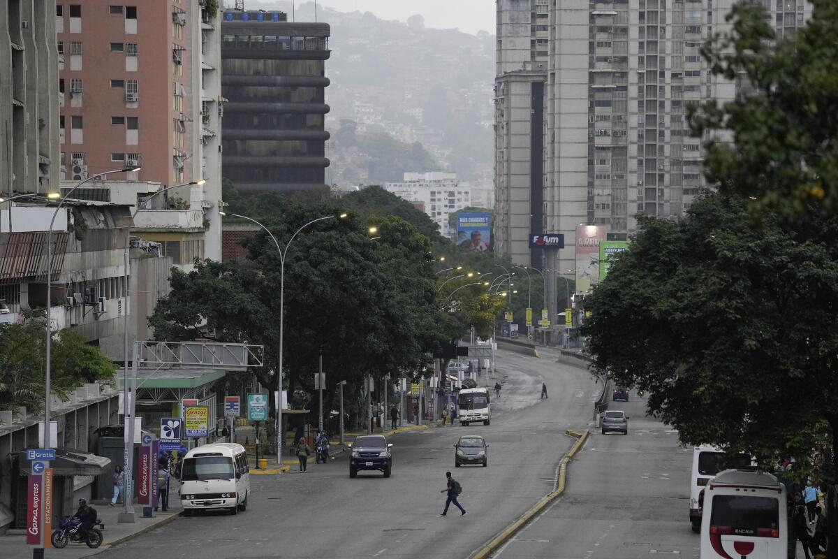 A man crosses an avenue in Caracas.