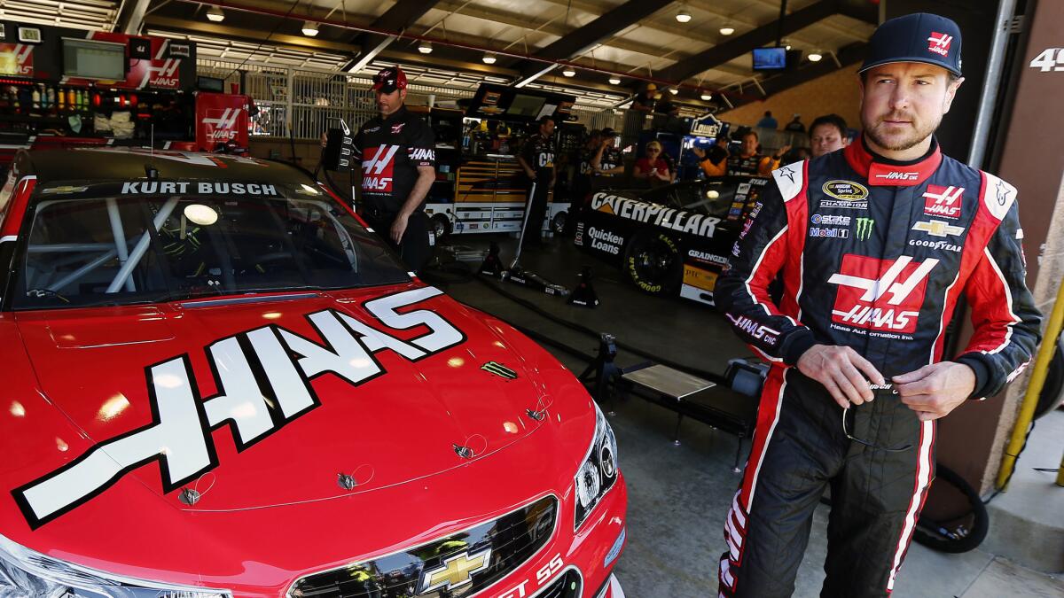 Kurt Busch stands in front of his car during NASCAR Sprint Cup Series practice at Auto Club Speedway in Fontana on Friday.