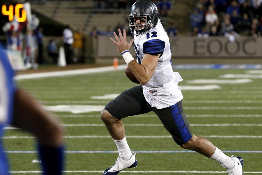 Memphis quarterback Paxton Lynch, who passed for a career-high 447 yards, runs for a touchdown in the third quarter against Tulsa on Friday night.