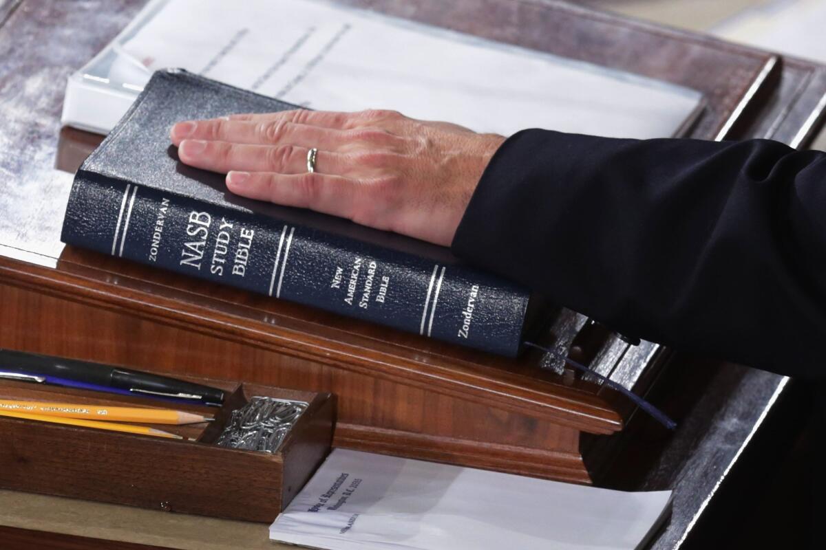 A member of Congress places his hand on a Bible in the House Chamber. Countries with higher rates of religiosity tend to fare worse on many measures of quality of life than more secular nations.