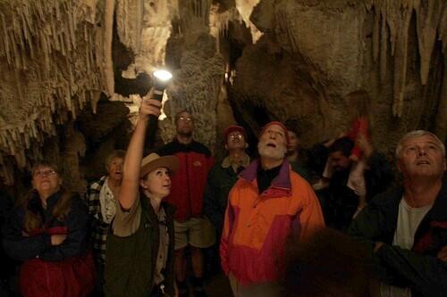 Great Basin National Park guide Jenny Hamilton, 25, leads visitors through Lehman Caves. The limestone structures have been forming for tens of millions of years.