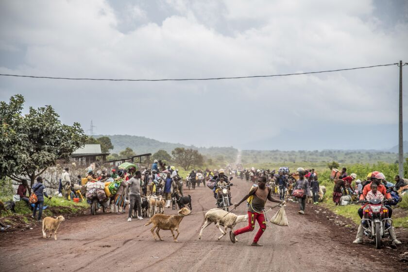 FILE - People walk on the road near Kibumba, north of Goma, Democratic Republic of Congo, as they flee fighting between Congolese forces and M23 rebels in North Kivu, Tuesday May 24, 2022. Decades-old tensions between Rwanda, one of Africa's most effective militaries, and Congo, one of its largest and most troubled countries, have spiked anew along their shared border a few hours' drive from Rwanda's capital, Kigali. Alarm has reached the point where Kenya's president is urging the immediate deployment of a newly created regional force to eastern Congo to keep the peace. (AP Photo/Moses Sawasawa, File)