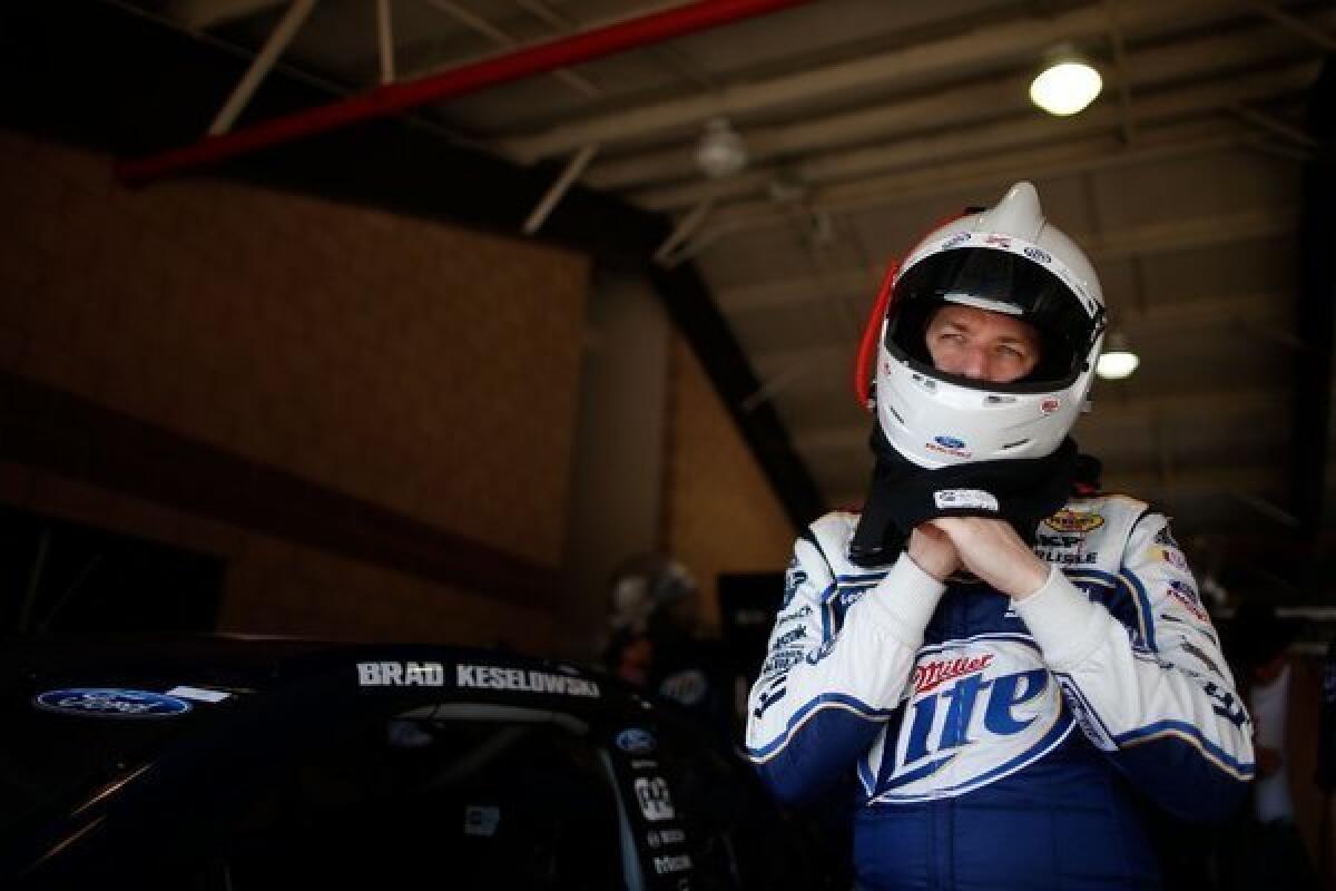 Brad Keselowski stands in the garage during practice for the NASCAR Auto Club 400.