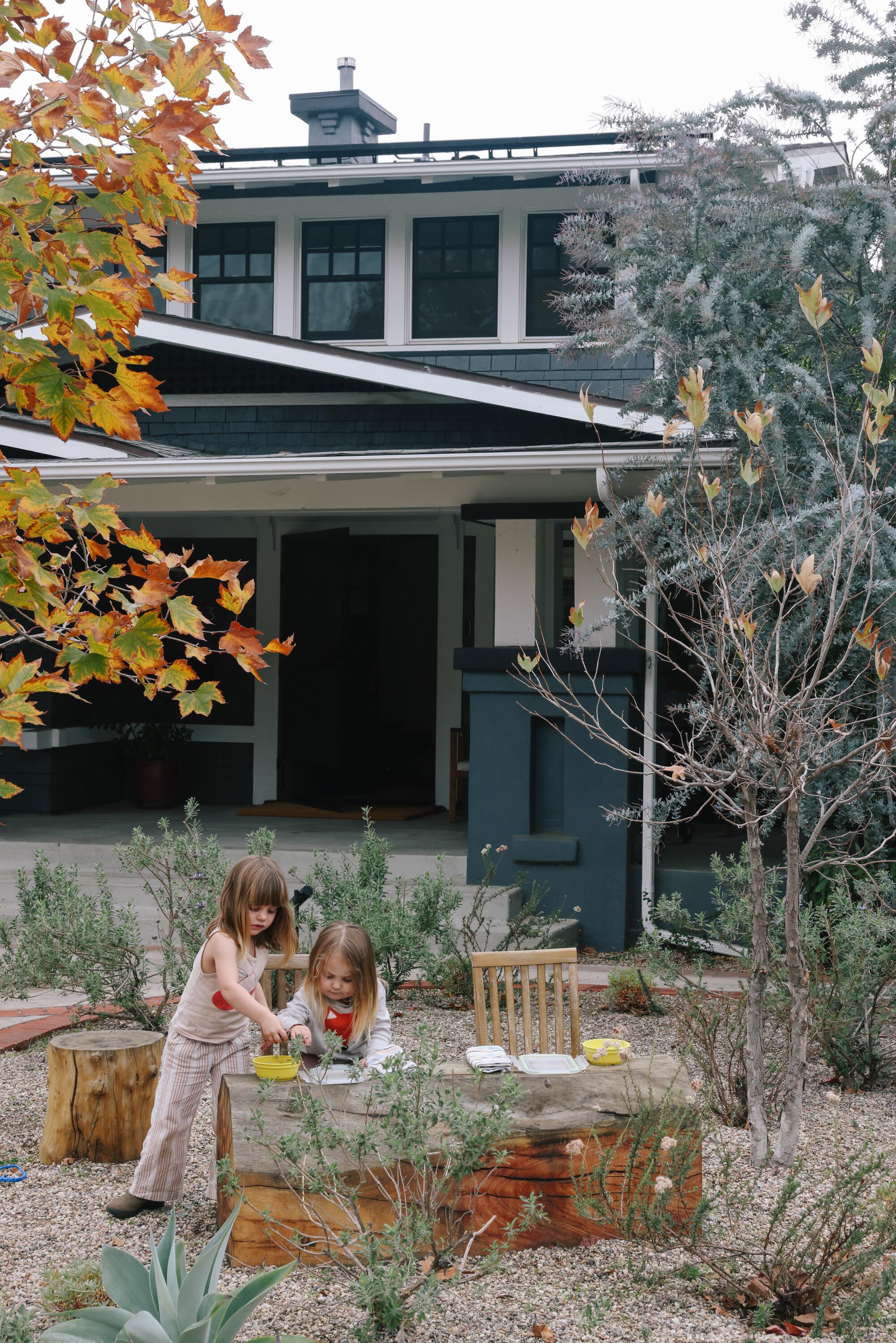 Two young girls play in their front yard 