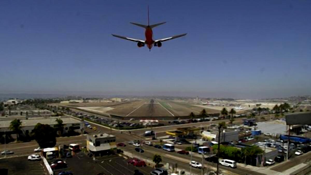 A plane descends for landing at San Diego International Airport.