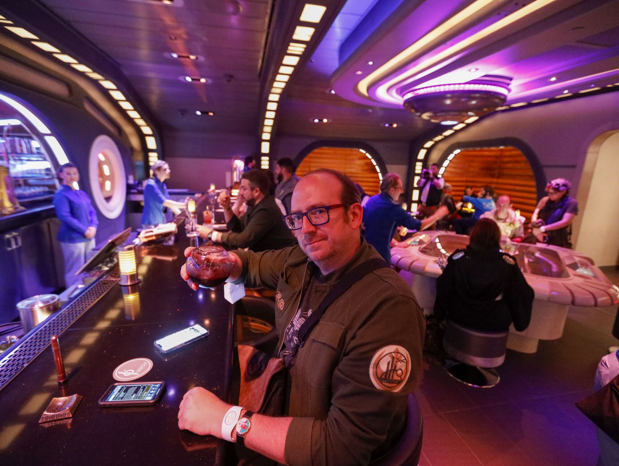 Los Angeles Times game critic Todd Martens checks out the scene in the bar aboard the Galactic Starcruiser