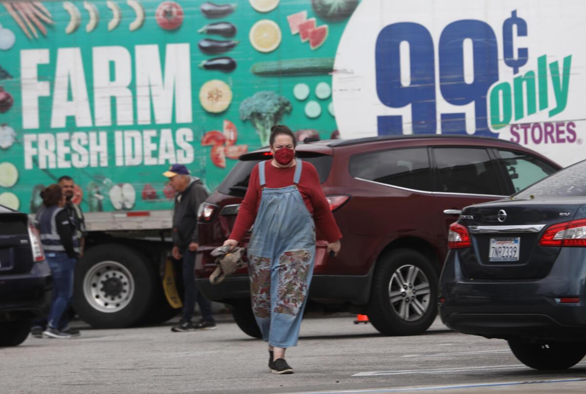 Cars try to find parking as a customer makes her way to the 99 Cents Only store in Santa Monica on April 5, 2024. 