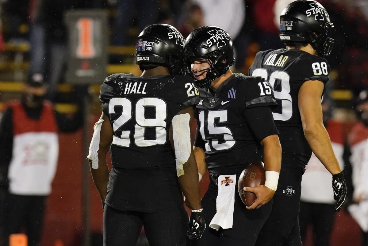 Iowa State quarterback Brock Purdy celebrates with teammate Breece Hall after scoring on a 2-yard touchdown.