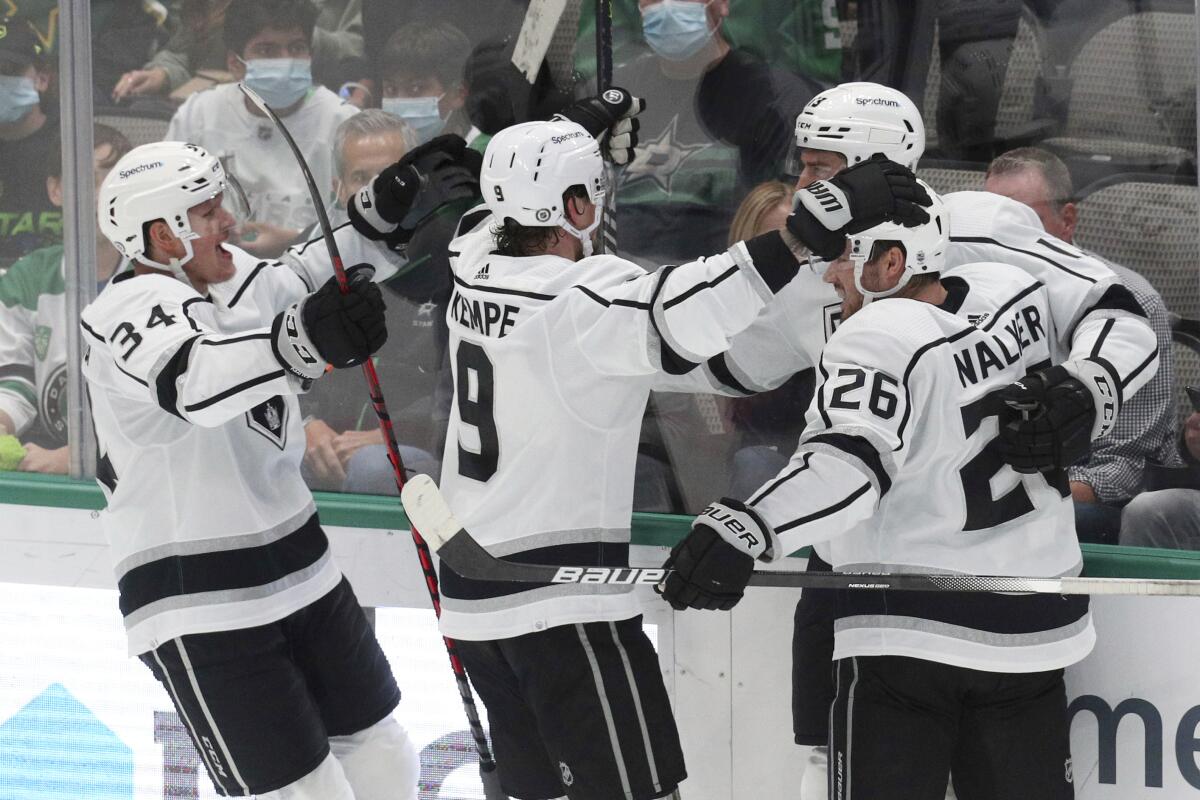 Kings Arthur Kaliyev, Adrian Kempe and Sean Walker celebrate a goal by center Gabriel Vilardi.