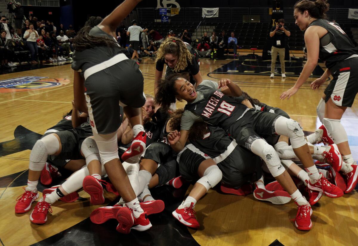 Mater Dei's Lani White (10) and teammates celebrate their win over Windward in the Southern Section Open Division final Feb. 28, 2020.