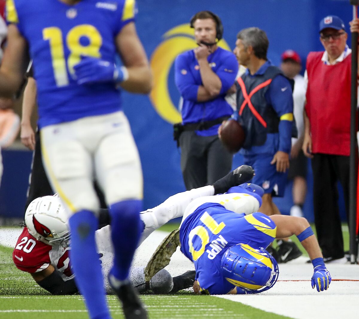 Cooper Kupp rolls out of bounds after Cardinals corner Marco Wilson landed on the receiver's leg and injured the receiver.