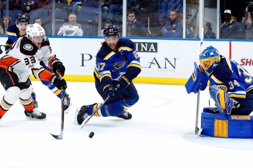 Anaheim Ducks' Jakob Silfverberg, of Sweden, and St. Louis Blues' Alex Pietrangelo, center, reach for a loose puck as Blues goalie Jake Allen, right, watches during the first period of an NHL hockey game Wednesday, Nov. 29, 2017, in St. Louis. (AP Photo/Jeff Roberson)