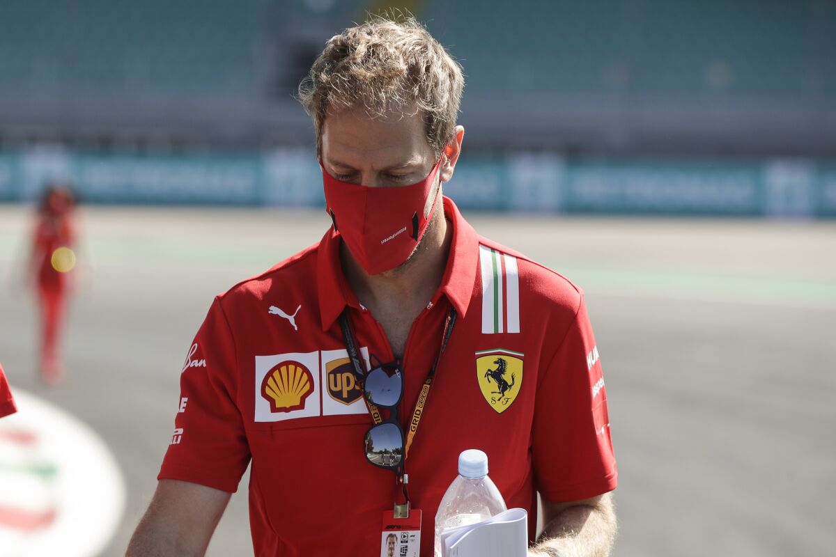 Ferrari driver Sebastian Vettel of Germany walks at the Monza racetrack in Monza, Italy, Thursday, Sept.3 , 2020. The Italian Formula One Grand Prix will be held on Sunday. (AP Photo/Luca Bruno)