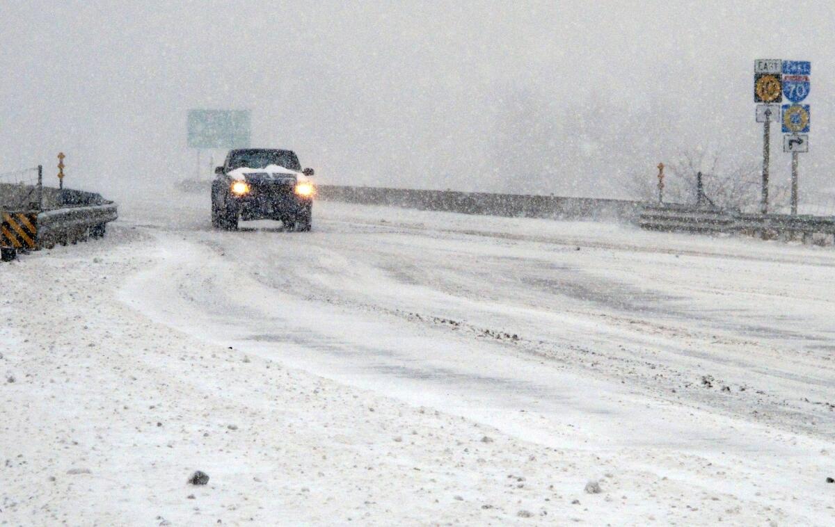 Heavy snow packs Kansas 10 at its junction with the Kansas Turnpike on Tuesday. A winter storm has shut down schools across Kansas and prompted government offices to close.