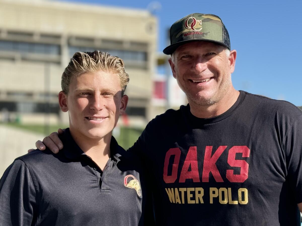 Oaks Christian water polo coach Jack Kocur, right, poses for a photo with his son, Cam, a standout player for the team.