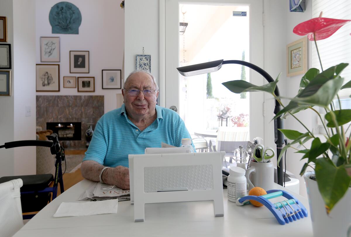 Walter Lachman, 92, at his home in Laguna Niguel. He counts on receiving a check from Germany around the 3rd of every month.