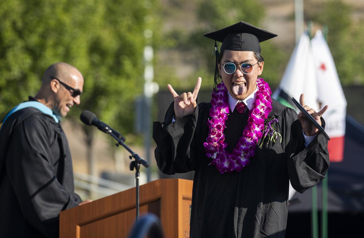 Anson Chen reacts after receiving his diploma during the Sage Hill School commencement on Friday.