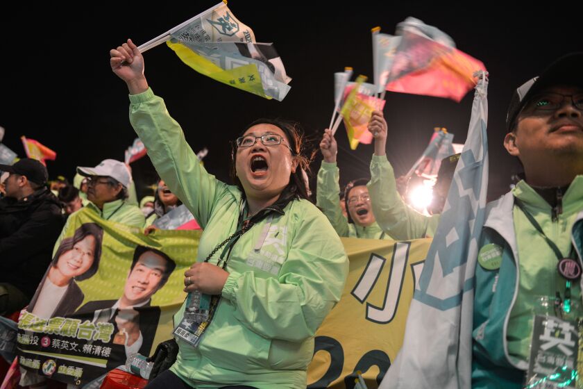 TAOYUAN TAIWAN, JANUARY 8, 2020: Wendy Yang (seated centre), 43, from Torrance, is a lawyer and tour leader of the 'Friends of Tsai Overseas' group (dressed in green jackets) here attending a pre-election rally in near Taoyuan city, North Taiwan, on 8th January 2020. The supporters have traveled from their homes in S. California to help support current Taiwan President Tsai Ing-wen's bid for a 2nd term in elections on 11th January. (Chris Stowers / For The Times)
