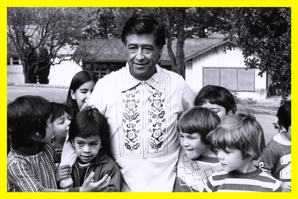 A man in a white shirt stands with a group of children.