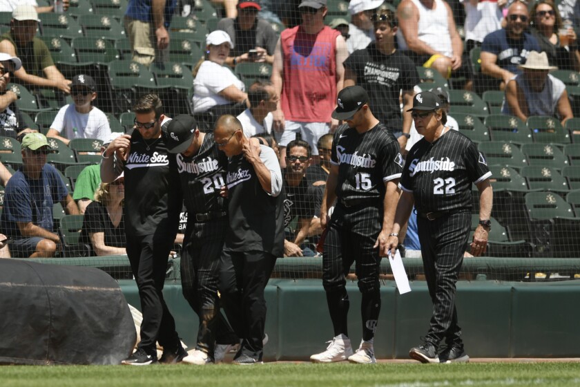 Chicago White Sox shortstop Danny Mendick (20) is helped off the field after being injured during the third inning of a baseball game against the Toronto Blue Jays Wednesday, June 22, 2022, in Chicago. Toronto won 9-5. (AP Photo/Paul Beaty)