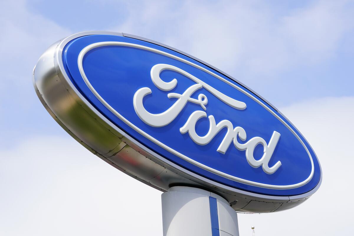 A Ford sign is shown at a dealership in Springfield, Pa., Tuesday, April 26, 2022. Ford is recalling more than 277,000 pickup trucks and cars in the U.S., Wednesday, Aug. 31, because the rear view camera lens can get cloudy and reduce visibility for the driver. The recall covers certain F-250, 350 and 450 trucks as well as the Lincoln Continental, all from the 2017 through 2020 model years.(AP Photo/Matt Rourke)