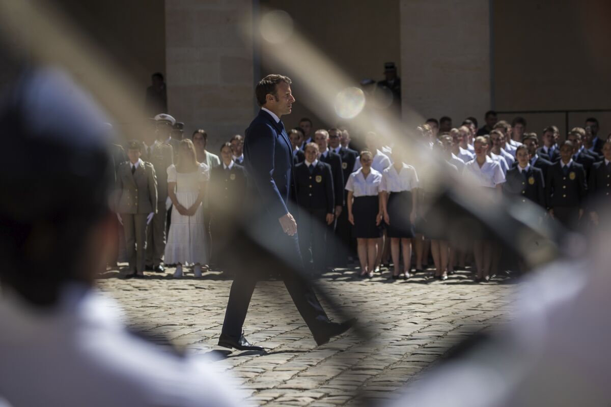 French President Emmanuel Macron attends a military ceremony at the Invalides monument in Paris, Monday, July 11 2022. The military ceremony is held to honor soldiers of the French Armed Forces. (Christophe Petit Tesson, Pool via AP)