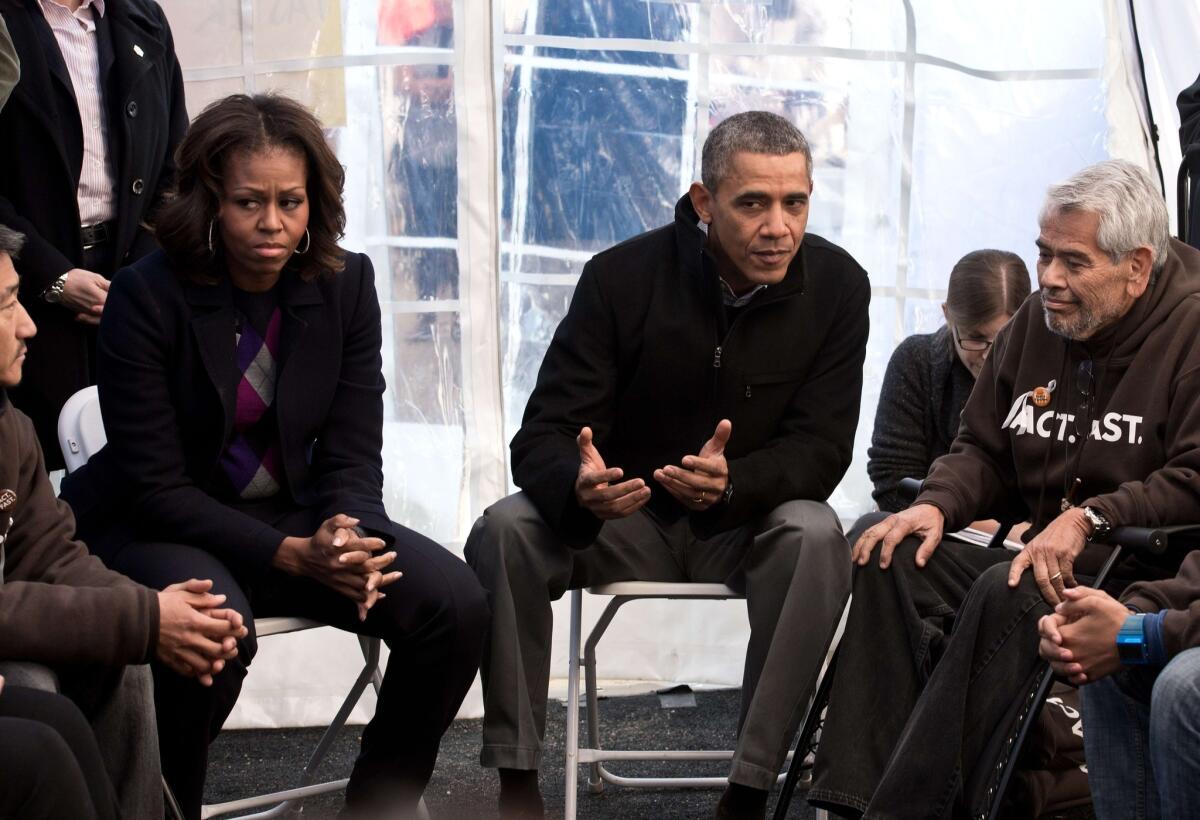 President Obama and First Lady Michelle Obama speak to people taking part in a Capitol Hill hunger strike on behalf of immigration reform. On the right is Eliseo Medina, who along with two others has not eaten in 18 days.
