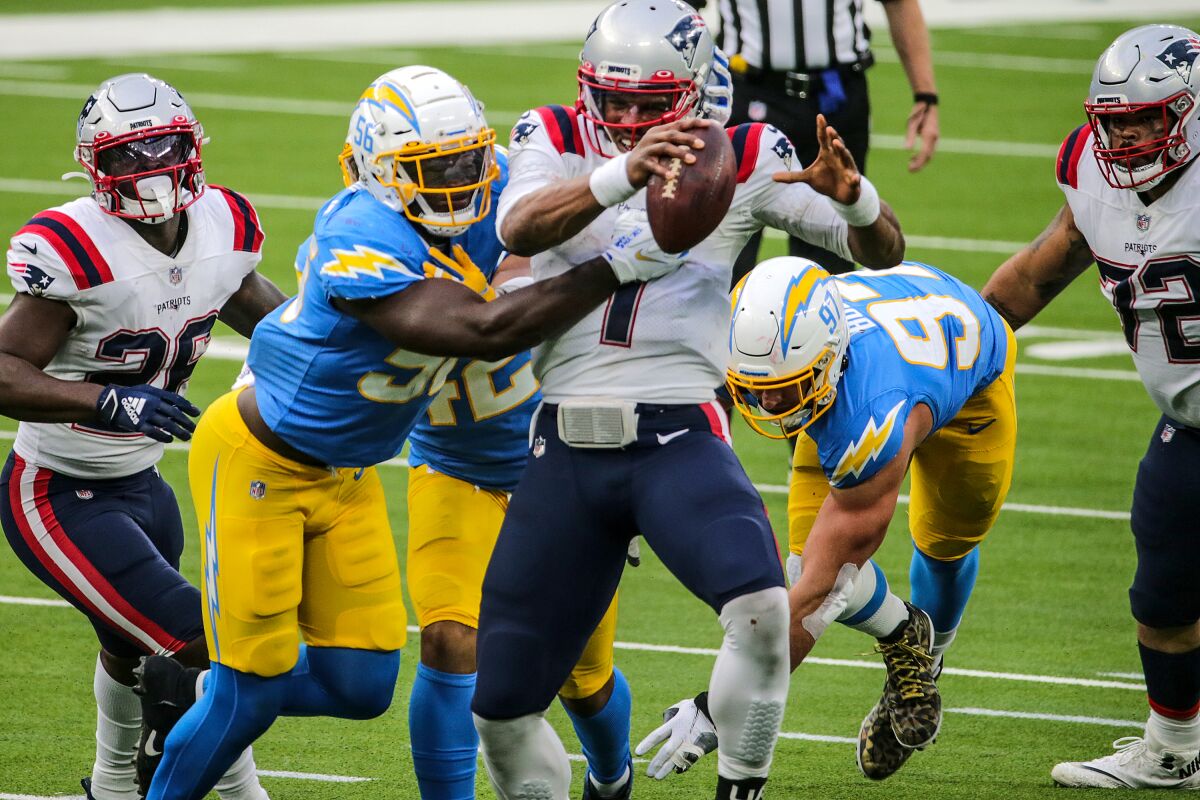 Chargers outside linebacker Kenneth Murray tackles New England Patriots quarterback Cam Newton.