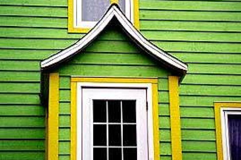 In St.-Pierre, clapboard houses painted in bright colors have small, enclosed front porches to keep out the cold.