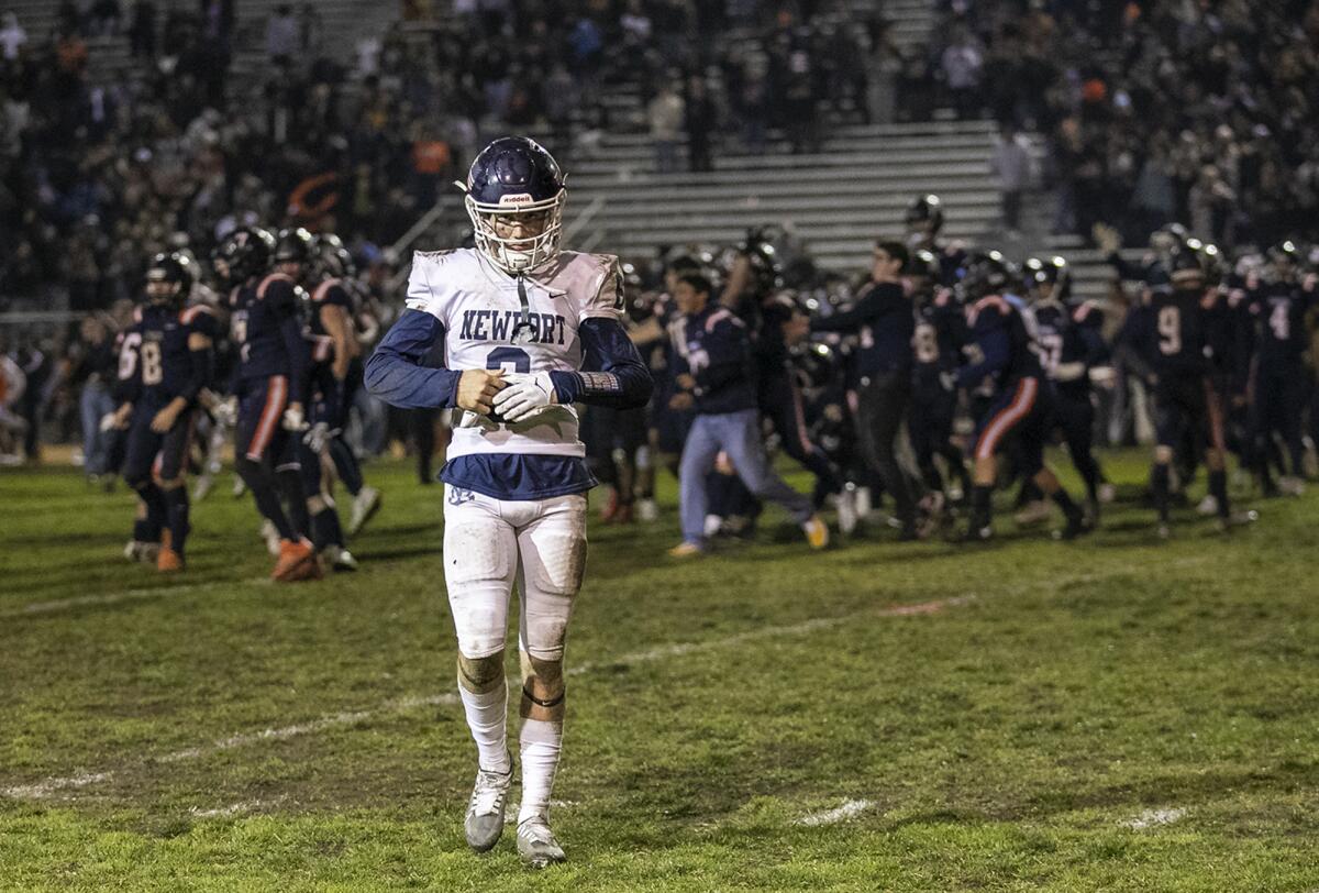 Newport Harbor's Kashton Henjum walks off the field after the Sailors lost to Cypress at Western High School on Friday.
