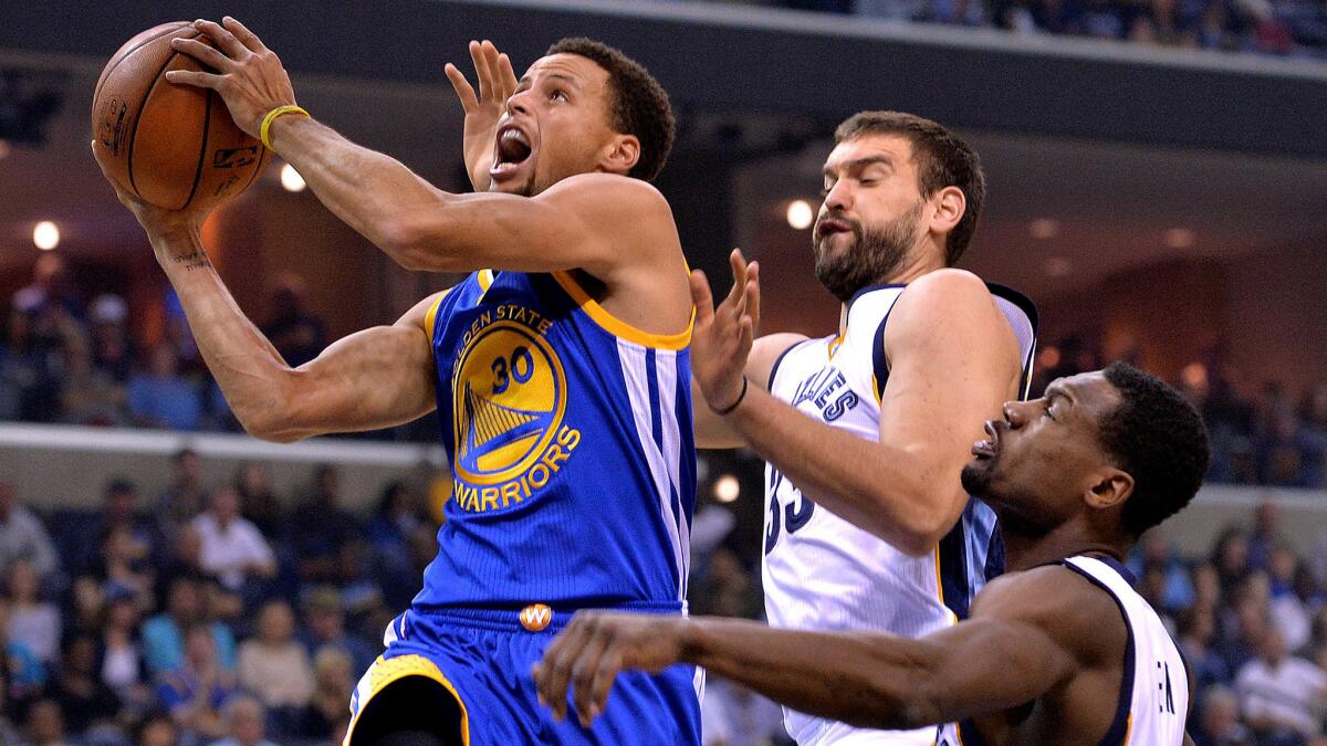 Warriors guard Stephen Curry drives to the basket against Grizzlies center Marc Gasol, center, and guard Tony Allen in the first half Wednesday night in Memphis.