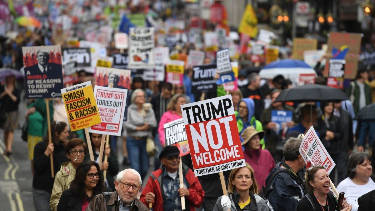 Protesters against President Trump march down Whitehall during demonstrations in London on Tuesday.