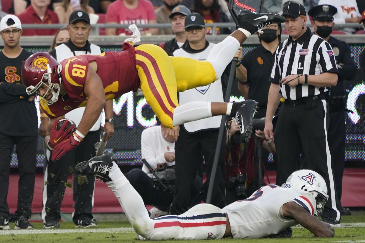 USC receiver Kyle Ford leaps over Arizona linebacker Christian Young 