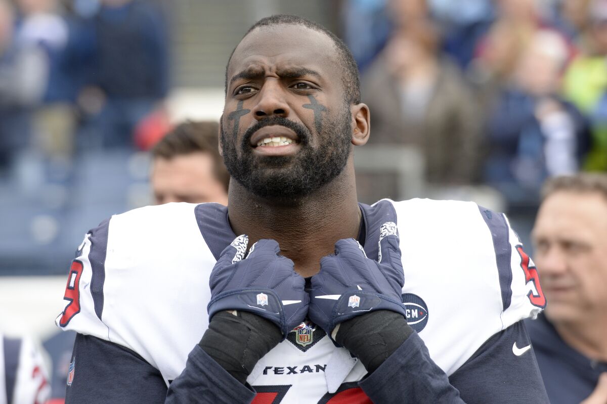 FILE - Houston Texans outside linebacker Whitney Mercilus stands for the national anthem before an NFL football game against the Tennessee Titans, Sunday, Dec. 15, 2019, in Nashville, Tenn. Outside linebacker Whitney Mercilus says he’s retiring, ending a 10-year career in which he recorded 58 sacks. Mercilus announced his decision Wednesday, April 6, 2022, via Instagram. (AP Photo/Mark Zaleski, File)